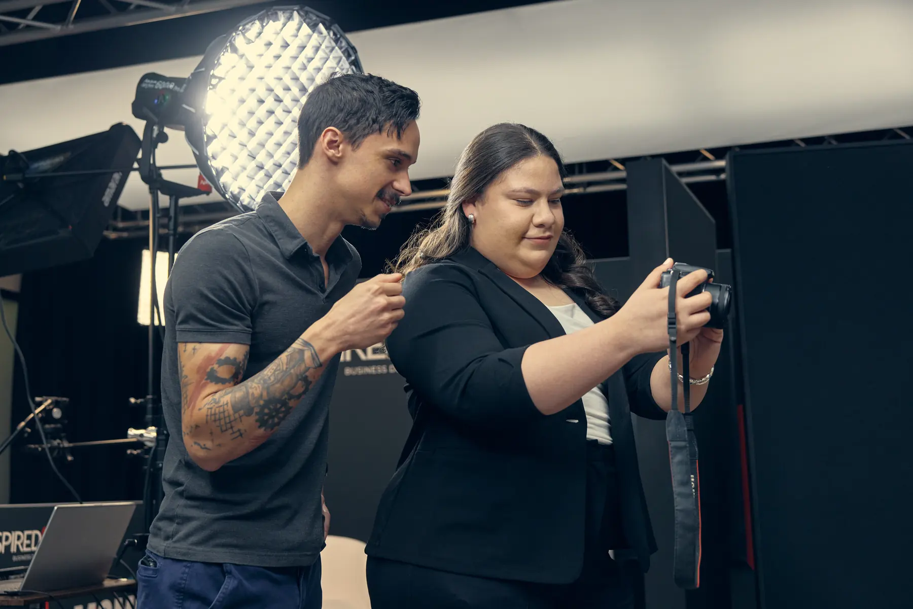 The crew adjusting a camera under studio lights